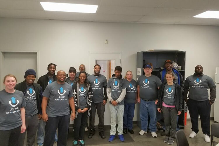 The Upshift team in branded shirts.